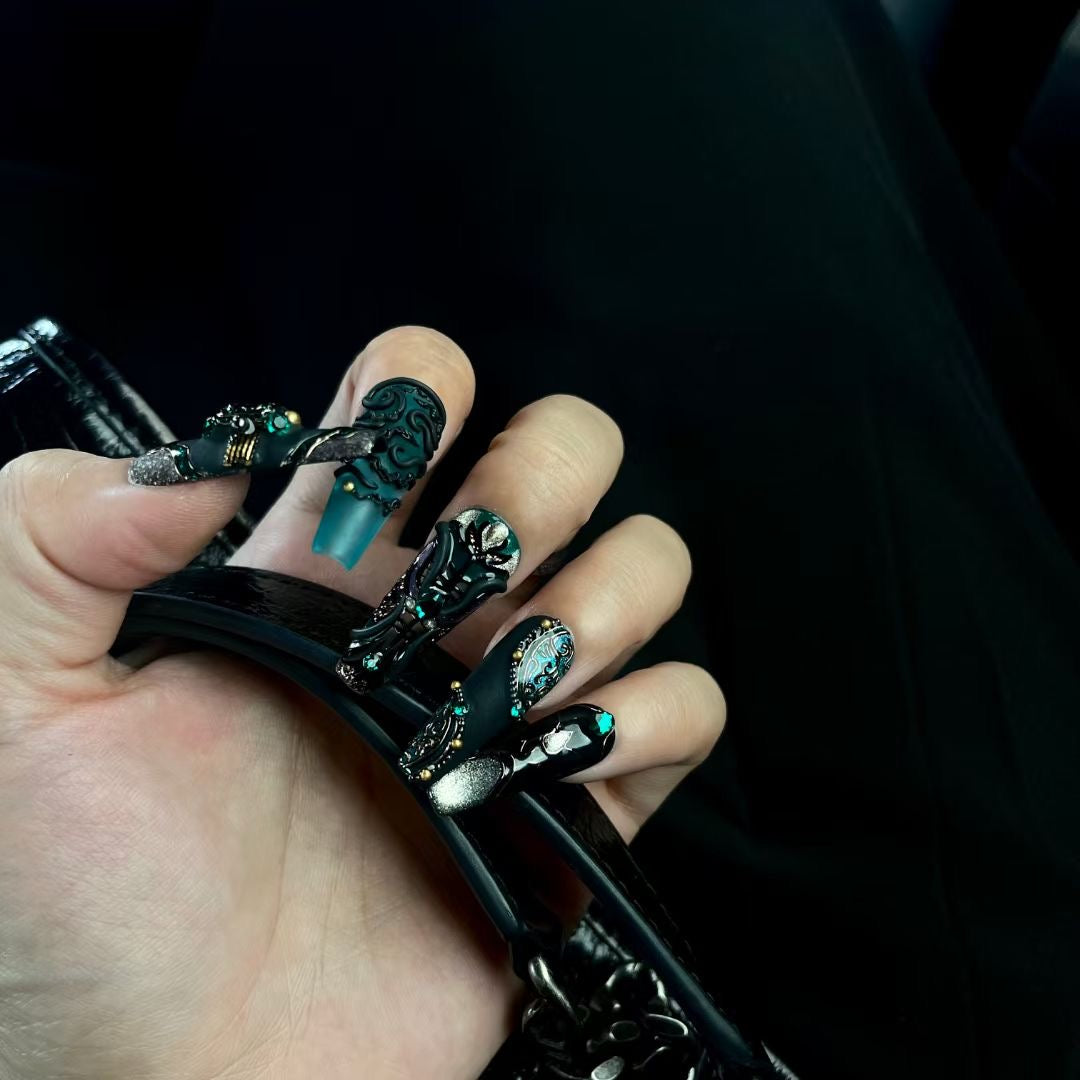 Black and green stiletto nails decorative effect on the hands